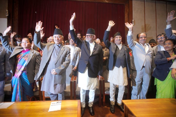 (l-r) Speaker Subhas Nembang, Prime Minister Sushil Koirala, UML Chairman KP Sharma Oli and UCPN(M) Chairman Pushpa Kamal Dahal wave at the press after signing the amended bill of the new constitution at New Baneswor on Friday.