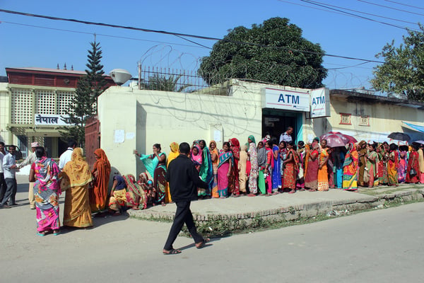 Hundreds of people line up to change the weekly INR 1,500 limit by showing citizenship certificates at the Birganj branch of Nepal Rastra Bank