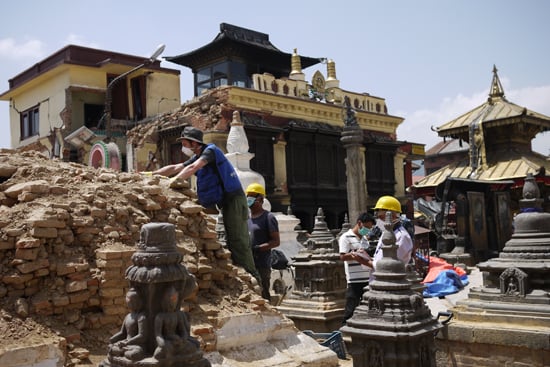 UN workers clean the debris at Swayambhunath Stupa on Wednesday.