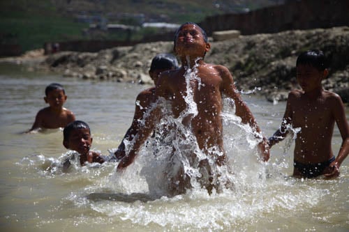 As temperature rises, young boys swim at Nakhu river on Tuesday.