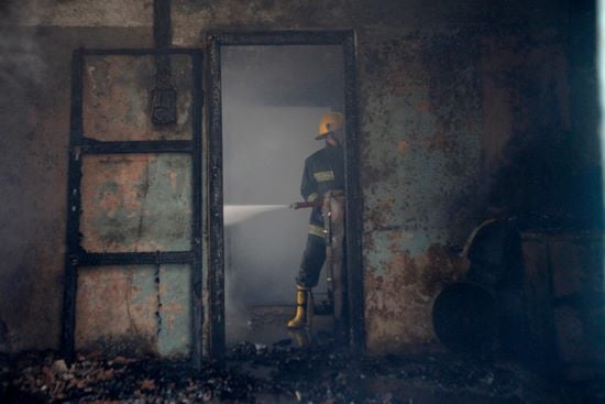 A firefighter tries to dowse the fire which broke out in the warehouse of Nepal Electricity Authority in Ratna Park on Thursday.