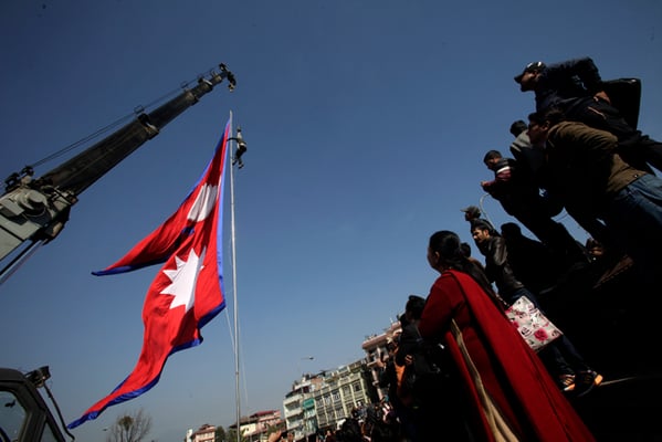 Nepali Patriotism Youth Society hoists a national flag on the occasion of Martyrs' day in Maitighar Mandala, Kathmandu on Sunday.
