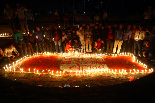 Members of the Nepal Student Union take part in a candlelight vigil after all the articles in the constitution bill are endorsed in Maitighar mandala on Wednesday.