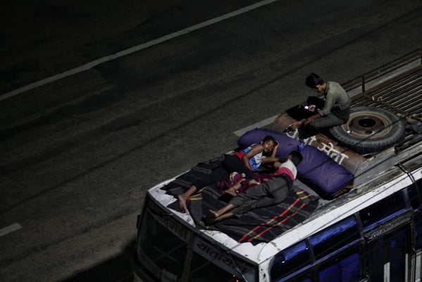 As temperature soars, staff of a long route bus take a little break atop the vehicle along the BP Highway on Saturday night.