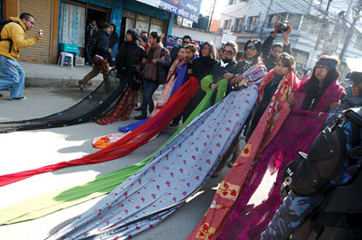 SARI BARRICADE: Members of Mandala theatre join the Occupy Baluwatar movement on Wednesday and protest against gender violence.