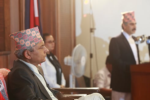ALL EARS : Khil Raj Regmi, Chairman of Electoral Council of Ministers looks on as Finance Minister Shanker Prasad Koirala unveils Nepal's budget for 2013/14 on Sunday evening.