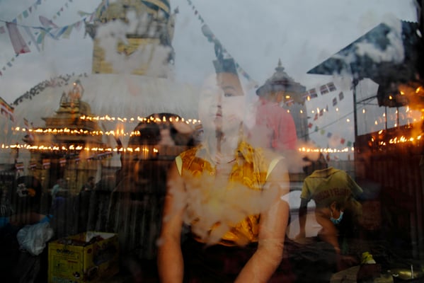 A child monk looks on as devotees visit the holy site to celebrate Buddha Jayanti at Swayambhunath on Wednesday.
