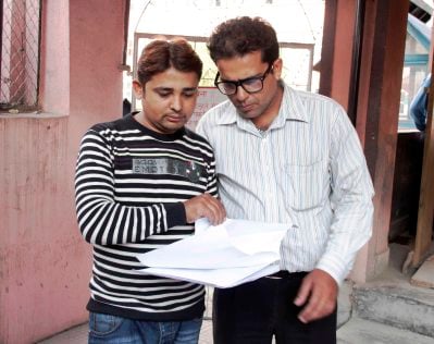 CAUGHT IN THE ACT: Journalists Parbat Raj Ghimire (left) and Baburam Acharya (right) file a petition on Sunday in the SC against CIAA chief Lokman Singh Karki.