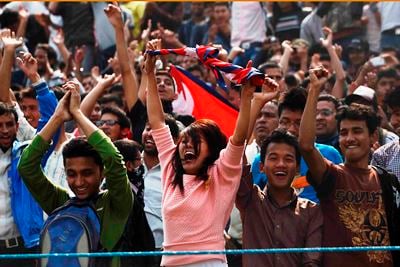 WE ARE THE CHAMPIONS: A Nepali fan cheers her cricket team during the match between Nepal and United Arab Emirates at Kirtipur on Tuesday.