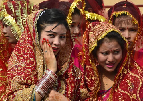Two brides in a mass wedding organised by Shivashakti Rahuleshwornanda Foundation, India in Pashupati on Sunday. One hundred couples took part in the ceremony.