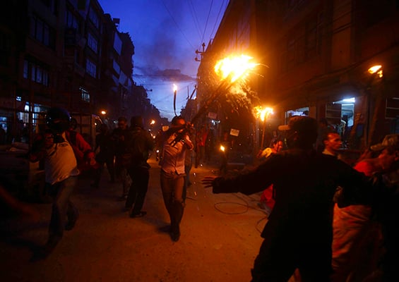 A protestor from the Tharu community shouts slogans during a torch rally in Kathmandu on Tuesday. They were protesting the division of Tharu-majority districts in the proposed federal structure.