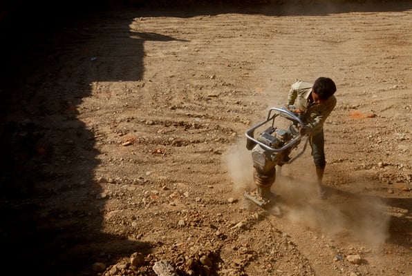 A worker levels the ground, where the Rato Machhendranath temple once stood, in Bungamati on Tuesday. The temple was destroyed in the April 2015 earthquake.