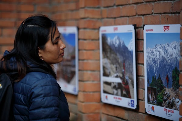 A visitor observes the photographs at 'Samriddhi Madhya Pachim' photo exhibition being held at Nepal Tourism Board, Kathmandu on Sunday.