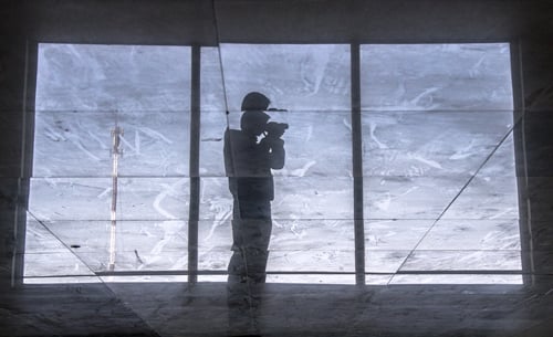 A visitor takes a picture through a window of the K.L. Tower in Chabahil.
