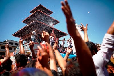 REFRESHMENT: People dancing during Holi festival get some fresh water from a tank at Basantapur Durbar Square on Tuesday.
