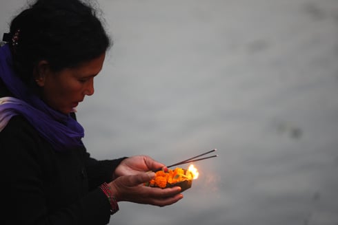 LIGHTS UP: A woman lights an oil lamp during the Bala Chaturdasi festival at the Pashupatinath on Monday.