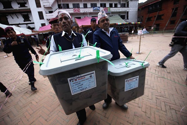 Officials carry the ballot boxes out of the polling station in Basantapur at the end of the first phase of local elections on Sunday.