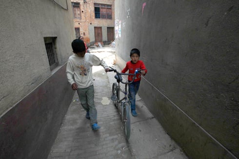 TRING TRING: Boys take their bicycle out for a ride after school in Lele.