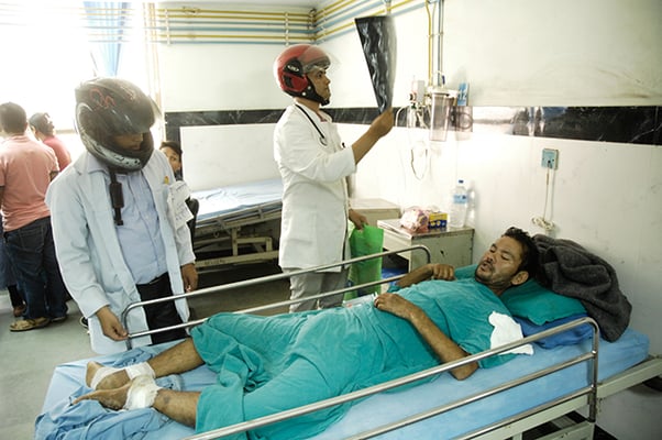 Doctors wearing helmets examine patients at the National Trauma Centre on Wednesday to protest assaults on health care workers.