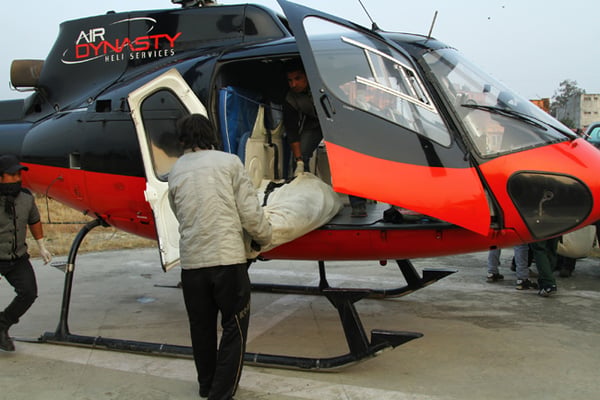 The body of one of the crew members of the Tara Air Twin Otter that crashed on Wednesday is brought to Kathmandu on Thursday.