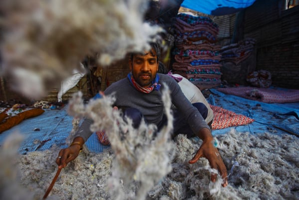Quilt maker Abdullah Khan beats wads of cotton wool to prepare quilt batting at a factory in Teku on Tuesday. Khan comes to Kathmandu every winter to sew quilts from his home in Bihar.