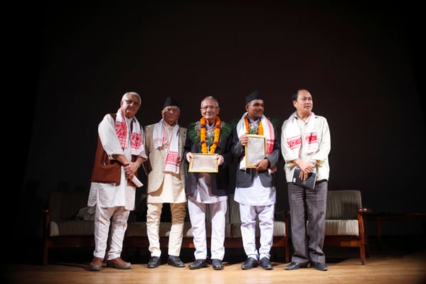 Lil Bahadur Chettri (third, left) and Ram Lal Joshi (second, right) on stage after receiving this year's Jagadamba Shree Puraskar and Madan Literature Prize respectively in Patan on Sunday.