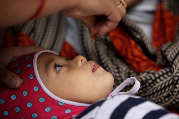 16-month-old Anisha Sapkota receives vitamin A supplement from a health worker at Baneshwor on Tuesday.