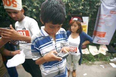 SMS ME: A boy checks the results of the SLC exams on his mobile phone at Sanothimi, Bhaktapur, on Tuesday.