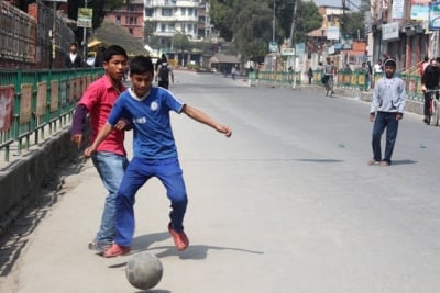 SPARE TIME: Boys enjoy some free time out of school playing football during the band called by the Federal democratic Front led by CPN-Maoist in Pulchowk on Wednesday.