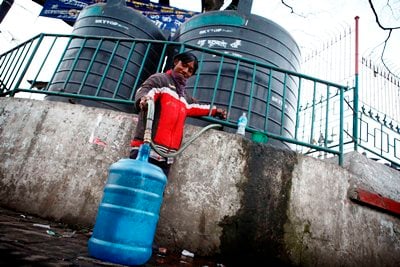 DRINKING WATER NOW: A man refills a water bottle from a private owned water tank at Lagankhel in Lalitpur on Saturday.