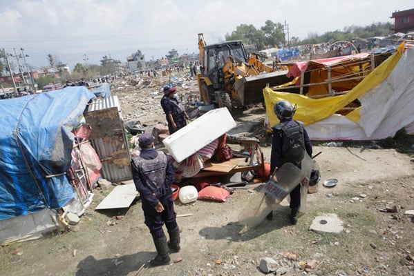 Police tear down temporary shelters inhabited by survivors of the April 2015 earthquake in Chuchepati, Kathmandu on Tuesday.