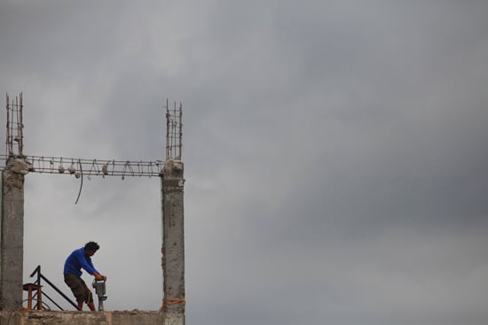 A man demolishes a house at Bungamati on Tuesday.