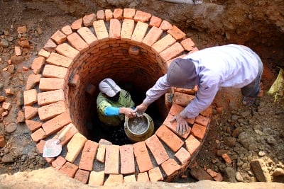 WISHING WELL: Workers fetch out water from a newly dug well, at Jawalakhel on Thursday morning.