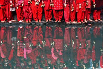HOLY WATER: Women holding water pots wait to fill them at the bank of Bagmati River during Swasthani Bratakatha festival at Pashupatinath Temple on Sunday.
