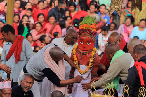 Priests decorate the idol of Machindranath before placing it in its chariot at Bungmati, Lalitpur on Sunday.