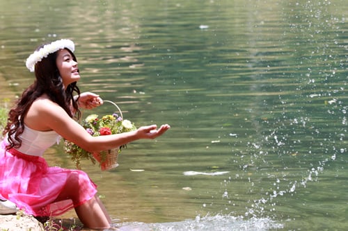 A girl plays with water in a pond at Godawari, Lalipur as temperature continues to rise.