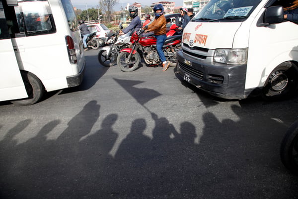 Motorists stuck in a traffic jam caused by a human chain formed to protest the Indian blockade at Maitighar on Monday.