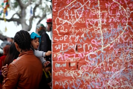 FIRST LETTER: FIRST LETTER: A young girl writes an alphabet on the wall of the Saraswati Temple near Swayambhu on Friday, the day marking the Goddess of Knowledge.