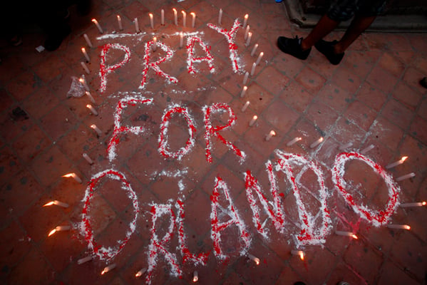 People light candles during a candle light vigil held in memory of victims of Orlando shootings at Basantapur on Friday.