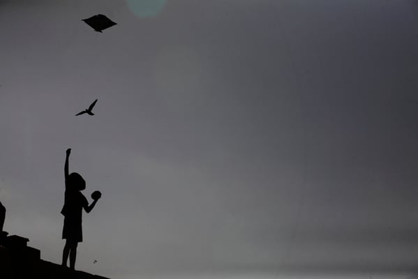 A little boy flies a kite from the collapsed temple at Jaisidewal on Tuesday.