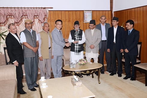 Nepal Telecom officials hand over a cheque to Prime Minister Sushil Koirala as contribution to the PM's relief fund, at Baluwatar on Friday.
