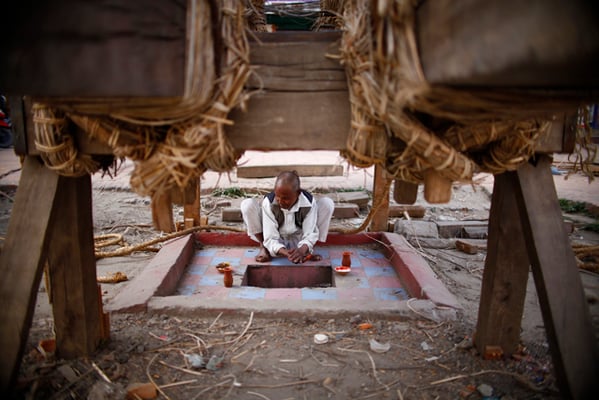 A Rato Machhendranath chariot maker offers samay baji to the idol of Kumari before his meal at Pulchok on Thursday.
