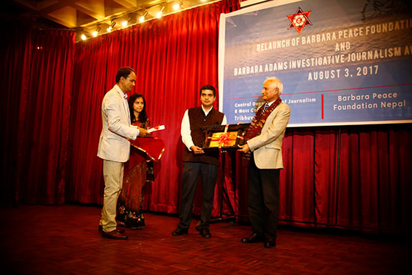 Journalist Krishna Gyawali receives Barbara Adams Investigative Journalism Award from Dr. Suresh Raj Sharma at the relaunch of Barbara Peace Foundation Nepal at Nepal Tourism Board on Thursday.