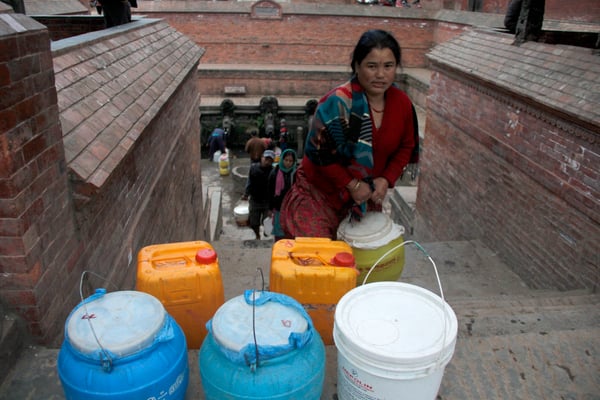WATER WOES: Growing water shortage in the valley forces locals to line up for water at the only Dhunge Dhara at Patan Durbar Square.