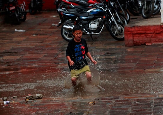 SPLASH : A young boy plays near Basantapur after the rainfall on Sunday afternoon.