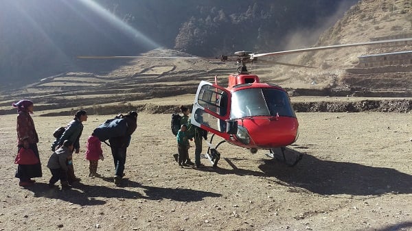 An earthquake-affected family flees the harsh Himalaya winter in the remote Upper Grokha village of Lho by a helicoper that had landed there to distribute relief on Sunday.