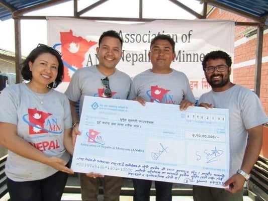 Sitaram Kattel (second from right) receives a cheque of Rs 20 million from the Association of Nepalese in Minnesota (ANM) in Mahottari on Monday. Kattel's organisation, Dhurmus Suntali Foundation, is building homes in Musahar community in Bardibas, Mahottari.