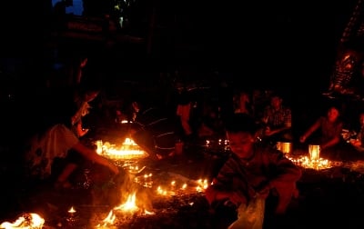NO WASTE: A boy collects previously used candles left at Rato Machindra Nath festival in Lagankhel on Tuesday.