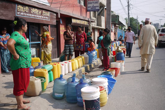 People queue up with water containers for drinking water at Gairidhara on Tuesday.