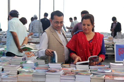 People flip through books at a book fair in Rastriya Sabha Griha on Wednesday.